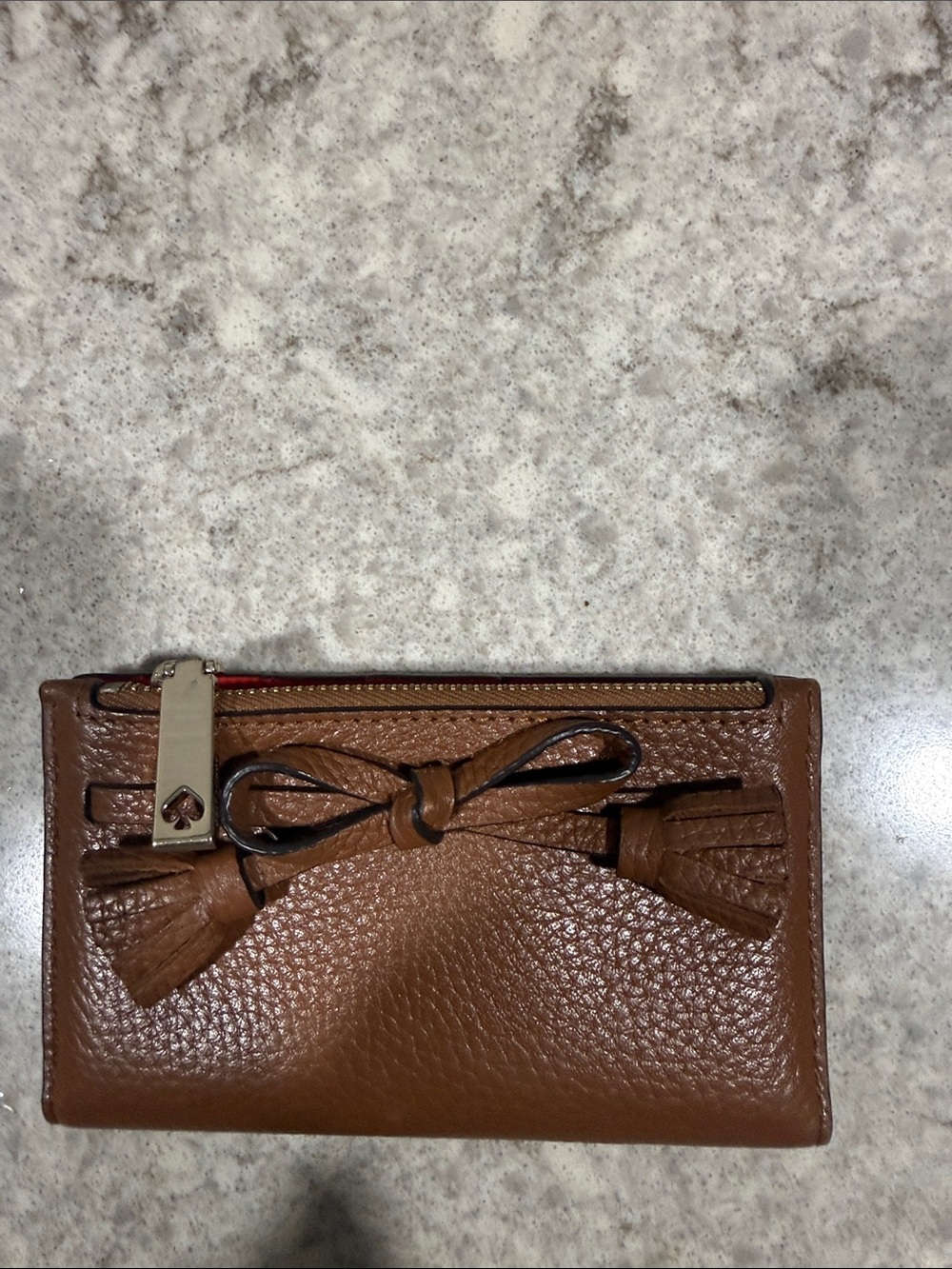 kate spade pebbled leather tassel bow zip wallet in brown